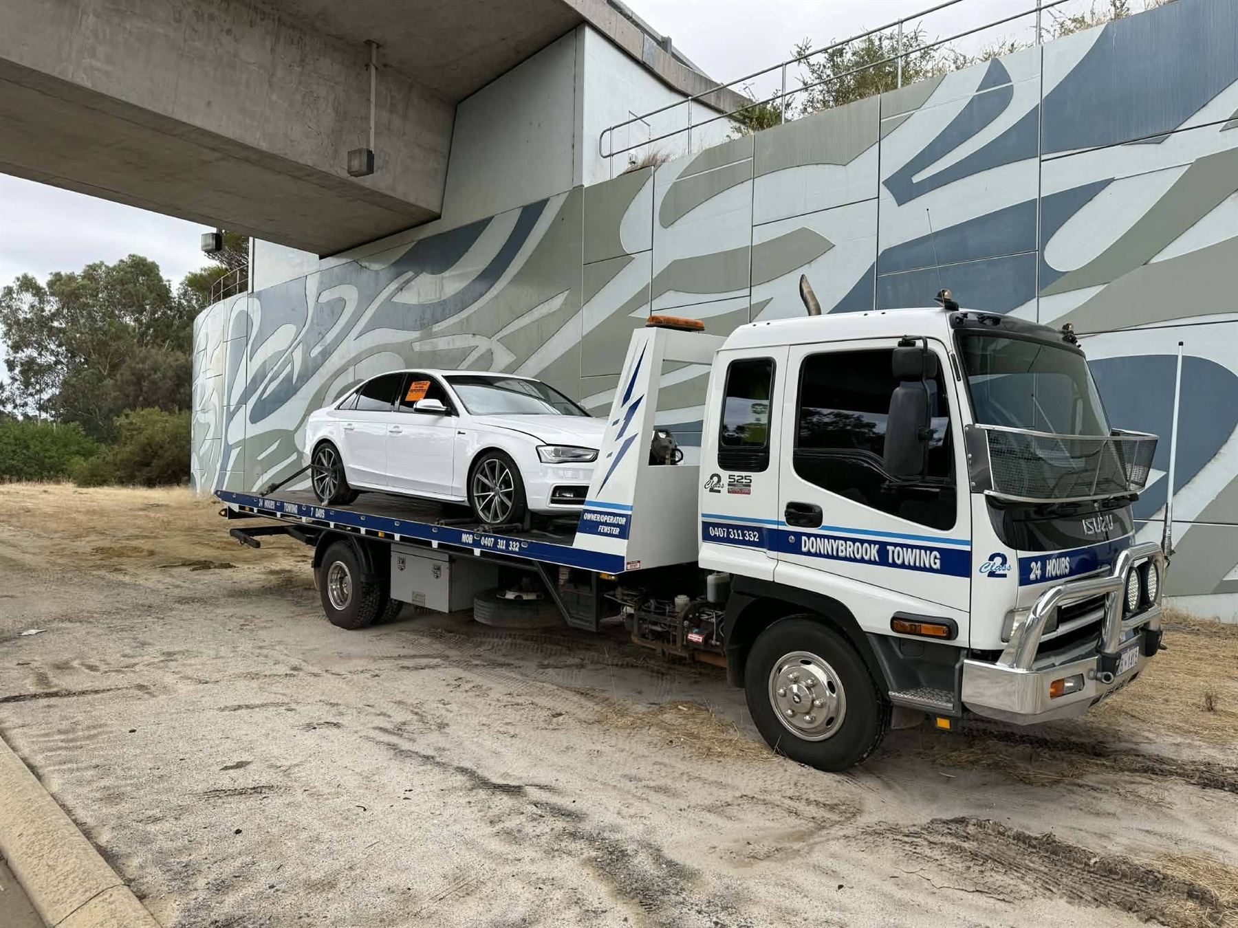 The white Donnybrook Towing tilt tray with its blue livery