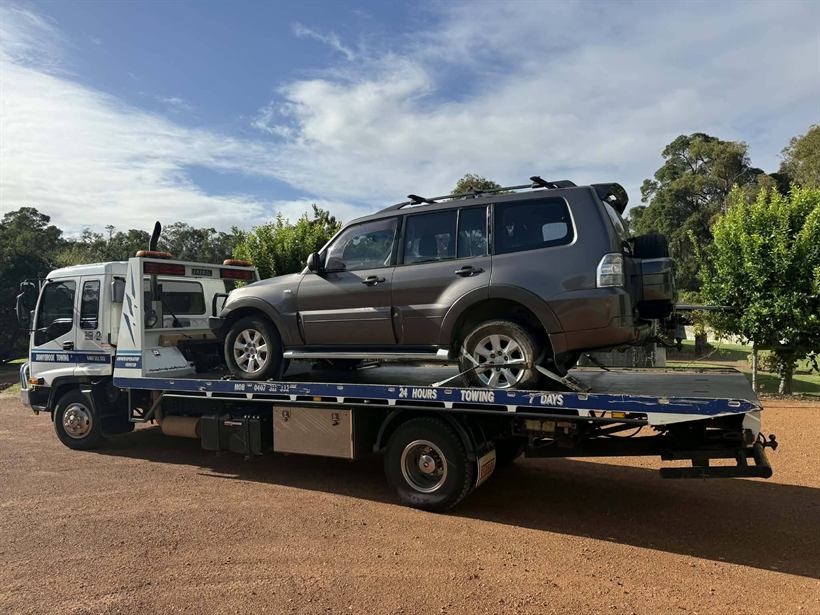 Mitsubishi Pajero loaded on the tilt tray on red dirt