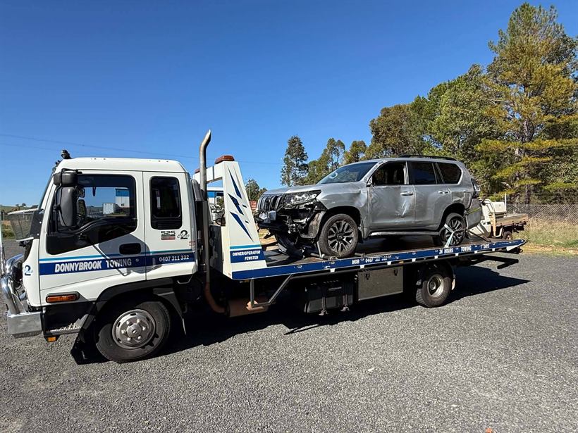 Accident-damaged silver SUV on the tilt tray